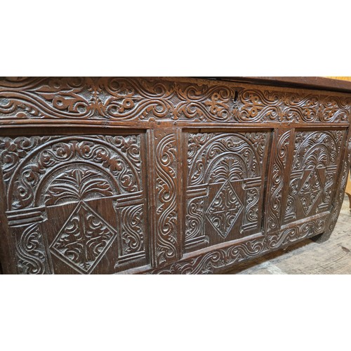 479 - Large oak 3 panel coffer with relief carved front