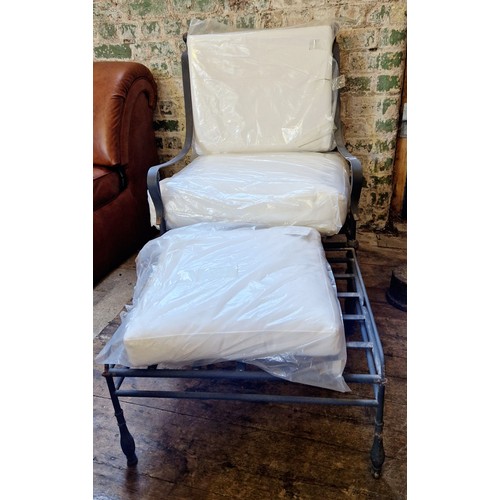 489 - Modern wrought metal framed chair and footstool with shower proof cushions