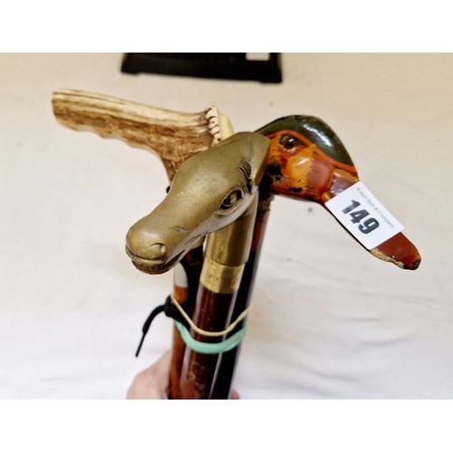 149 - Three walking sticks with antler, horse form and brass duck handles