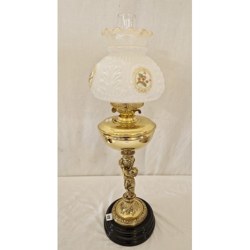 172 - Brass oil lamp with ornate base in the form of Putti and floral glass shade