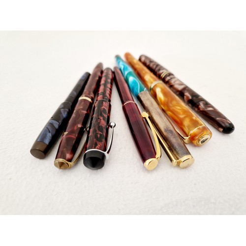 224 - A collection of seven mottle cased fountain pens including three Conway Stewart Dinkie lever fill 14... 