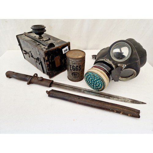 240 - Militaria comprising British WWI bayonet, gas mask, tin of dried egg etc