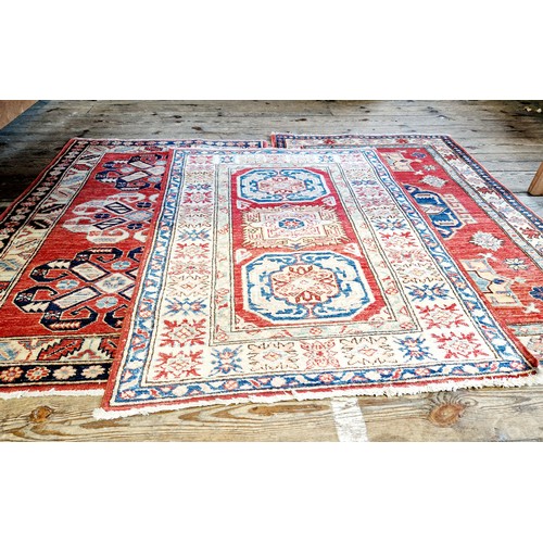 307 - Three Pakistani woollen patterned rugs with various geometric design approx. 130cm x 80cm / 120cm x ... 