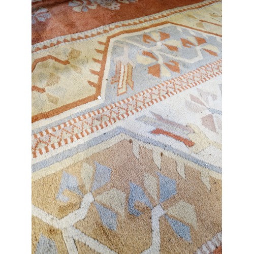 312 - Turkish woollen rectangular rug with terracotta geometric floral design approx. 290cm x 205cm