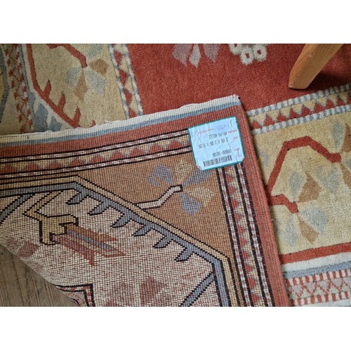 312 - Turkish woollen rectangular rug with terracotta geometric floral design approx. 290cm x 205cm