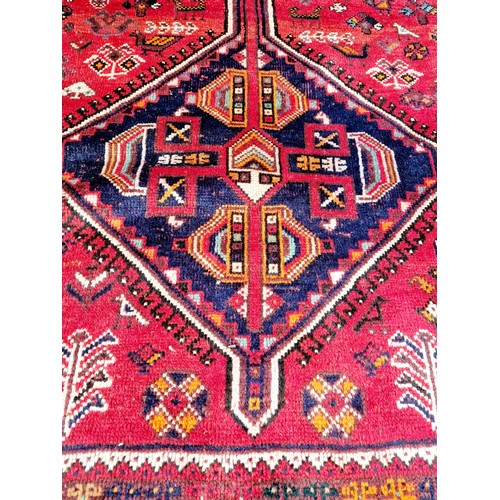 315 - Afghan woollen rectangular rug with red and blue geometric design approx. 300cm x 225cm