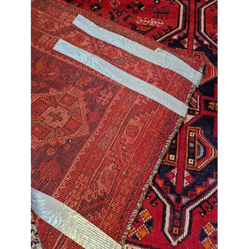 315 - Afghan woollen rectangular rug with red and blue geometric design approx. 300cm x 225cm