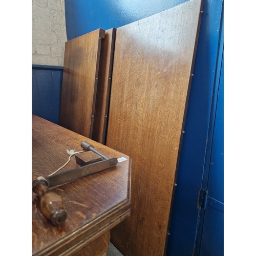 327 - Edwardian oak rectangular wind-out dining table with 3 spare leaves on turned legs to castors