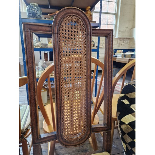 338 - Pair of early 20th century oak framed hall chairs with rattan panels and shaped stretchers