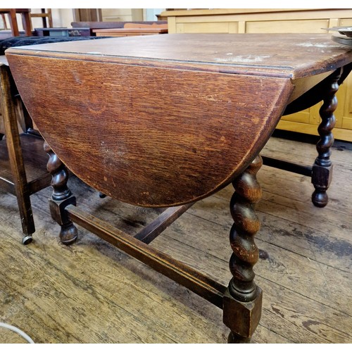 358 - Early 20th century oak D-ended drop-leaf table on barley twist legs