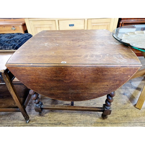 358 - Early 20th century oak D-ended drop-leaf table on barley twist legs