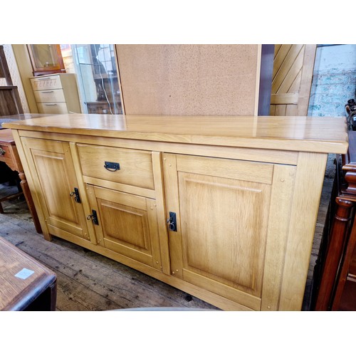 387 - Modern oak side board with central single cutlery drawer over cupboards below and either side