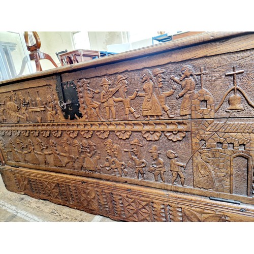 393 - Continental large oak Cassone with carved fall front depicting music figures with iron plate and key