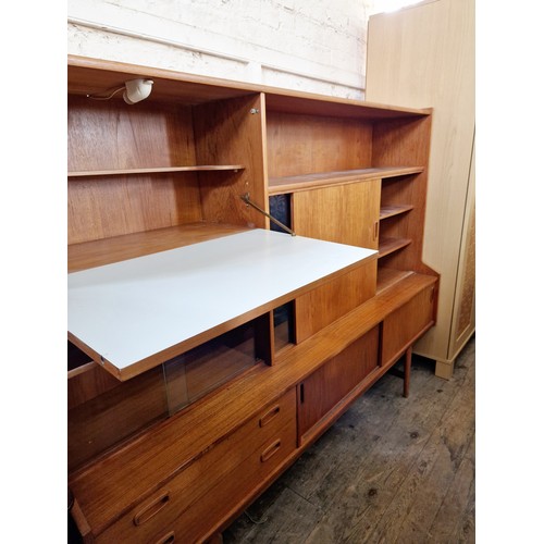 399 - Vintage teak side cabinet with various glazed and solid sliding cupboard doors and drawers, a fall f... 