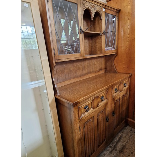 403 - Mid-century oak dresser with upper leaded glazed doors over a base of 2 drawers and cupboard with re... 