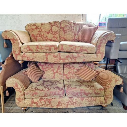 408 - Pair of modern floral upholstered red and gilt settees on turned feet to brass castors