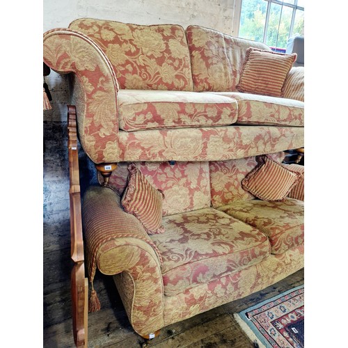 408 - Pair of modern floral upholstered red and gilt settees on turned feet to brass castors