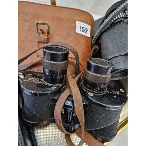 152 - Leather cased set of 1944 6x30 binoculars, Tasco 7x15x35 binoculars and a Samsung 145S 35mm camera