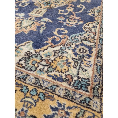 274 - Rectangular multi coloured floral patterned rug on blue ground approx. 220cm x 120cm