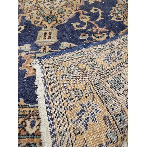 274 - Rectangular multi coloured floral patterned rug on blue ground approx. 220cm x 120cm