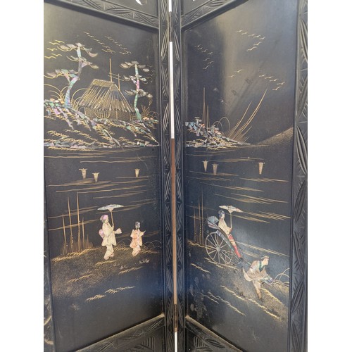 283 - Ebonised oriental four-panel screen with mother of pearl inlay pictorial panels