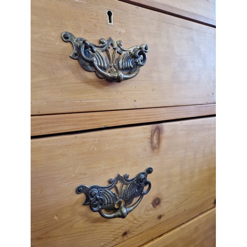 287 - Early 20th century pine chest of 2 over 3 graduating drawers, brass drop handles and shaped apron