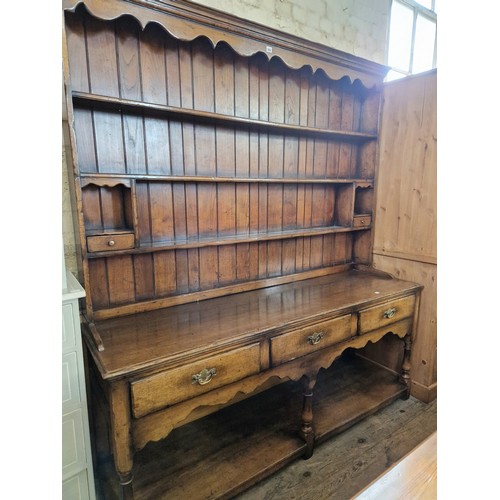 355 - Titchmarsh & Goodwin mid-century oak dresser, with plate rack over a base of three drawers with shap... 