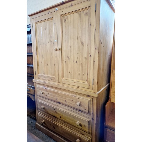 356 - Modern pine linen press with shelved upper cupboard over a base of 3 drawers