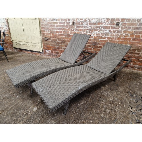 405 - A pair of faux raffia garden loungers