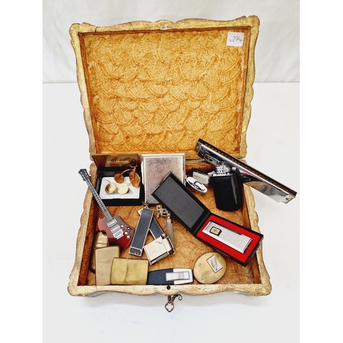 240 - Papier Maché box with various collectors item incl. harmonica, cigarette lighters, yellow metal broo... 