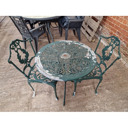 488 - Modern pierced metal circular garden table and two chairs