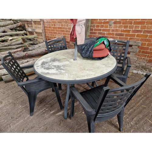 489 - Metal circular garden table, parasol and four plastic chairs