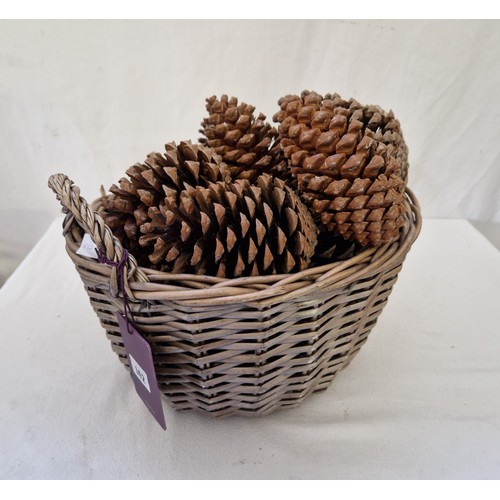 142 - Wicker basket containing large pine cones