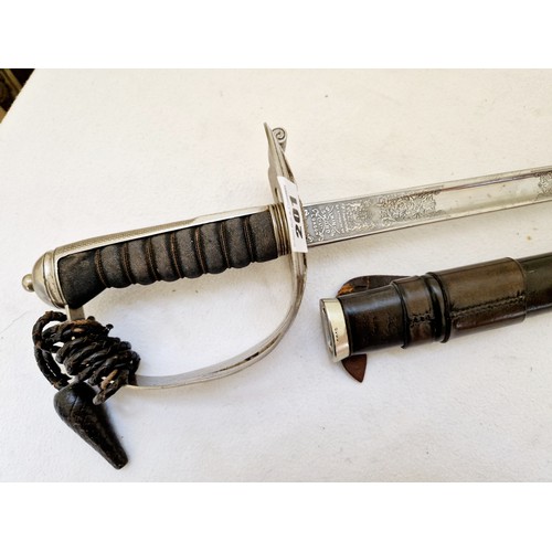 201 - A British cavalry sword with pierced guard, wire bound fish skin grip in a leather-bound scabbard by... 