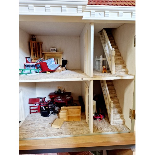 268 - Modern plastic bay fronted dolls house and contents