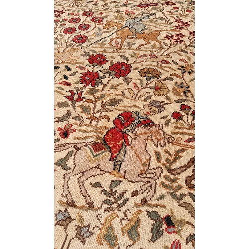 294 - Large rectangular woollen carpet with profuse hunting scenes on a red and cream ground approx. 400cm... 