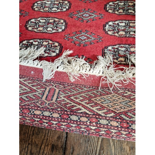 287 - Red patterned Afghan woollen rug approx. 182cm x 130cm