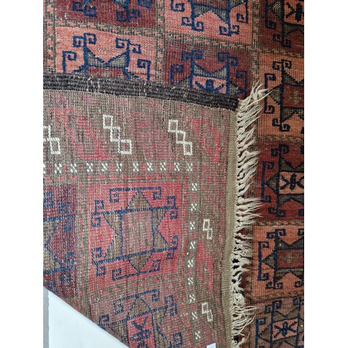 292 - Afghan red geometric rectangular patterned woollen rug approx. 153cm x 92cm