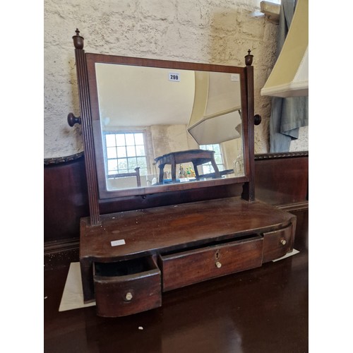 299 - 19th century mahogany rectangular toilet mirror with fluted supports on a shaped base with three dra... 