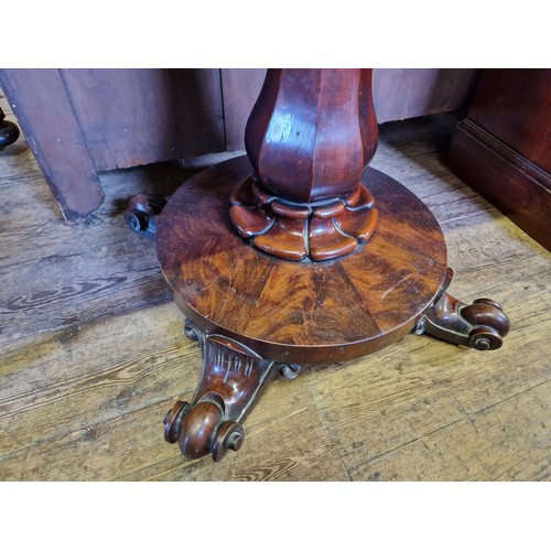 357 - Victorian mahogany fold over tea table with octagonal tapering support to circular base and four scr... 