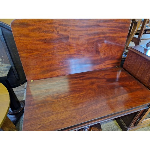 357 - Victorian mahogany fold over tea table with octagonal tapering support to circular base and four scr... 