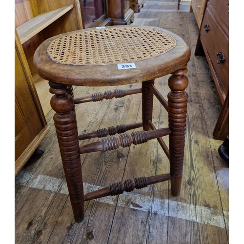 391 - Early 20th century mahogany stool with rattan seat and bobbin turned supports