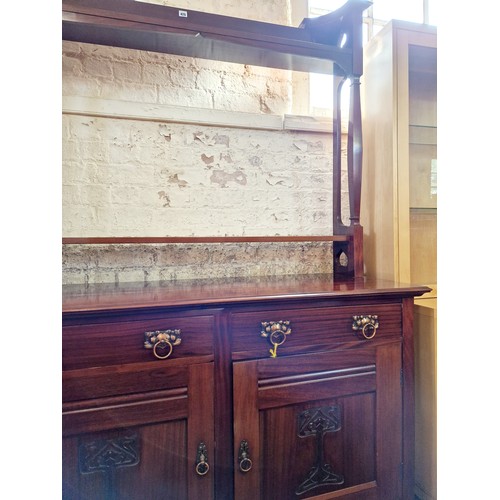 425 - Edwardian Art Nouveau dresser with two frieze drawers over a cupboard base with relief panels