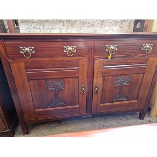 425 - Edwardian Art Nouveau dresser with two frieze drawers over a cupboard base with relief panels