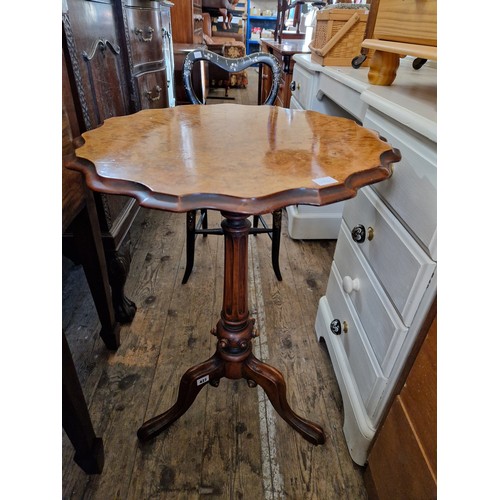 427 - Early 20th century walnut and mahogany pie crust table on turned support