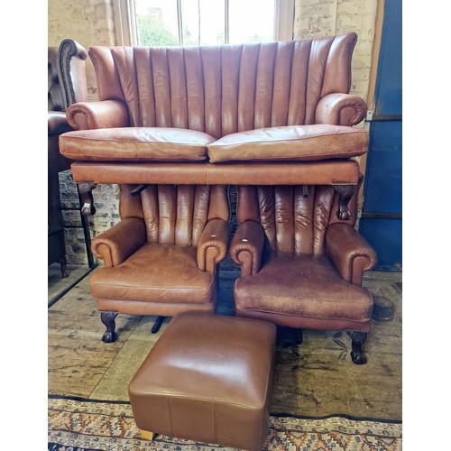 436 - Reproduction brown leather three-piece suite comprising settee and two armchairs on ball and claw fe... 