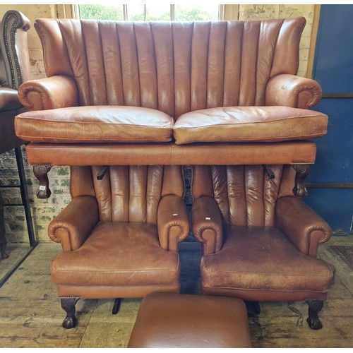 436 - Reproduction brown leather three-piece suite comprising settee and two armchairs on ball and claw fe... 