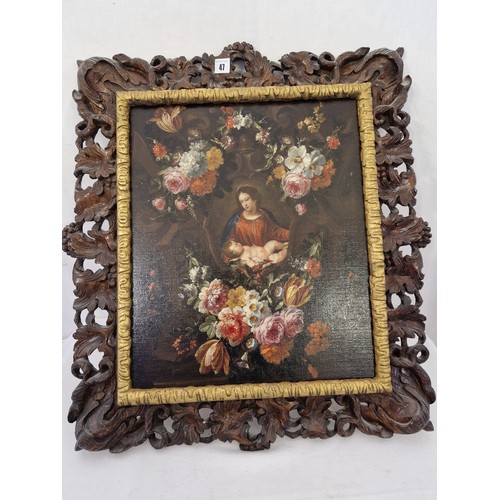 47 - Oil on canvas of mother and child in floral surround with a dark oak foliate pierced frame approx. 3... 