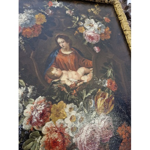 47 - Oil on canvas of mother and child in floral surround with a dark oak foliate pierced frame approx. 3... 