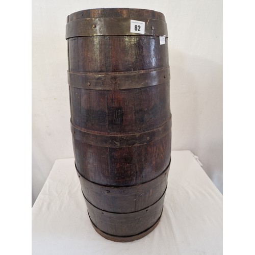 82 - Oak barrel form stick stand with metal banding. 67cm tall